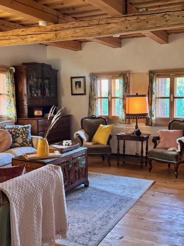 a living room with couches and tables and windows at Copacis Country Home in Breb