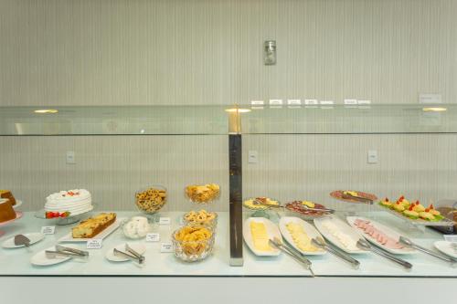 a display case filled with different types of food at Hiber Hotel - Acesso a Chapecó in Chapecó