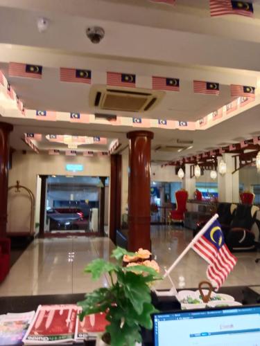 a lobby with an american flag on a table at hotel bintang in Kuala Lumpur