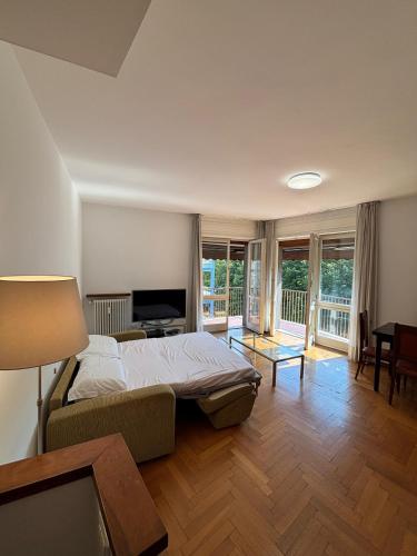 Un dormitorio con una cama y una sala de estar. en Lake side and view - new bright apartment, en Lecco