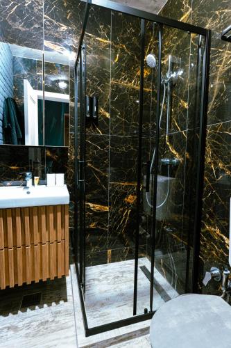 a bathroom with a shower with a glass door at The Industry in Galaţi