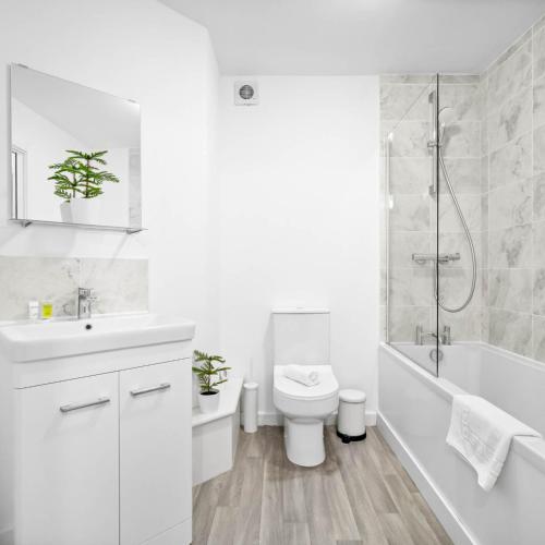 a white bathroom with a toilet and a shower at Stylish Two Bedroom Apartment - Sleeps Three - Secure Parking - Fast WiFi 53C in Sleightholme