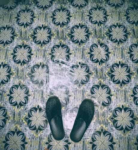 a pair of black shoes on a tile floor at Ghaa Bomet BnB in Bomet