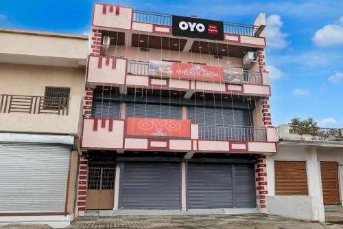 a tall pink building with a sign on it at Hotel O IMPERIAL in Jabalpur