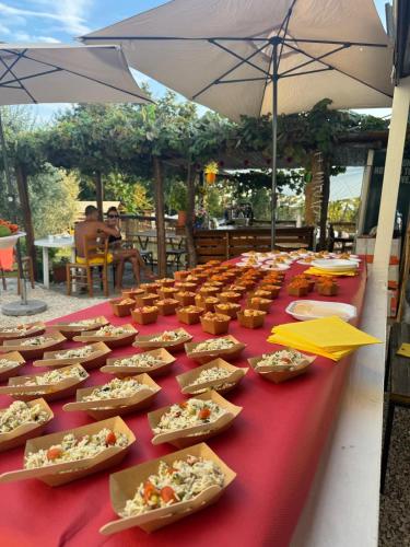 a long red table with plates of food on it at Agriturismo Da Nonna Argia in Massa e Cozzile