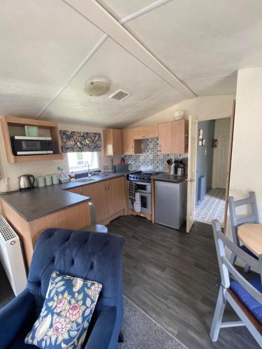 a kitchen and living room with a blue couch at The Old Inn Retreat in Spilsby