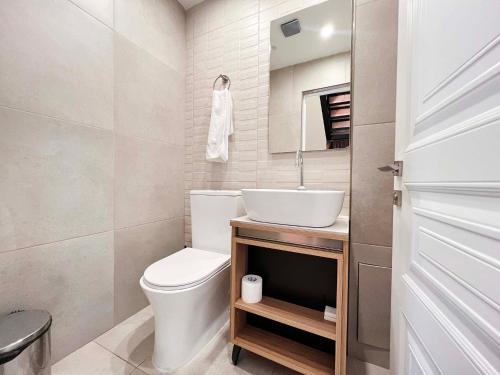 a bathroom with a white toilet and a sink at Motives Inn Dilijan in Dilijan