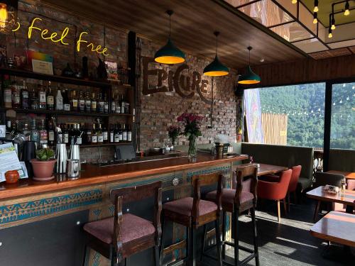a bar in a restaurant with tables and chairs at Motives Inn Dilijan in Dilijan