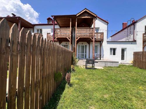 a wooden fence in front of a house at Motives Inn Dilijan in Dilijan