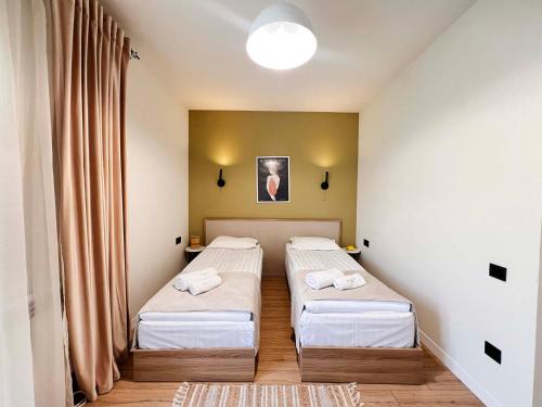 a room with two beds in a room at Motives Inn Dilijan in Dilijan