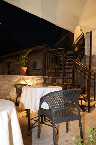 a dining room with a table and chairs and stairs at Oda e Gurit - Boutique Hotel in Berat