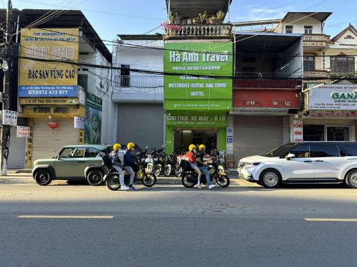 a group of people on motorcycles on a city street at Hà Anh Hostel in Ha Giang