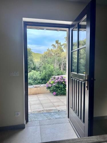 an open door with a view of a garden at Sisco Nature in Sisco