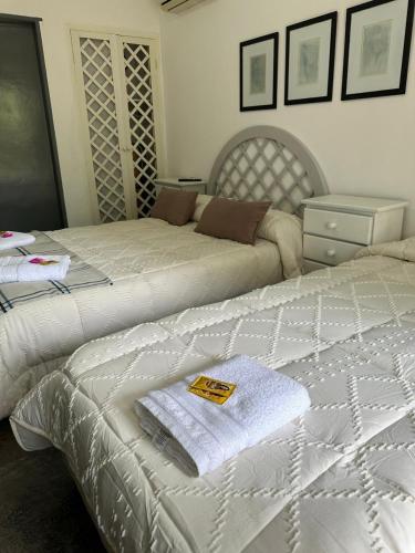 a bedroom with two beds with towels on them at Hotel Mare Dona 10 in Punta del Este