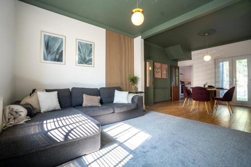 a living room with a couch and a table at Modern 6 Person Cosy Cottage in Historical Newport in Caerleon