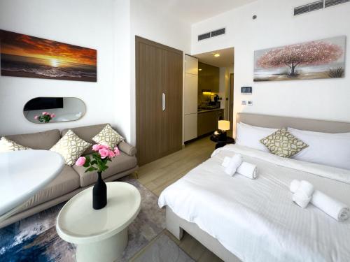 a hotel room with two beds and a couch at Luxe Studio Vibes Stylish & All New Pet Free in Dubai