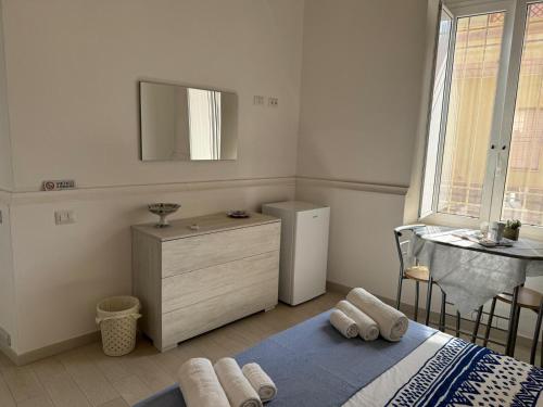 a bedroom with a bed and a dresser and a mirror at B&B Il sogno in Cagliari