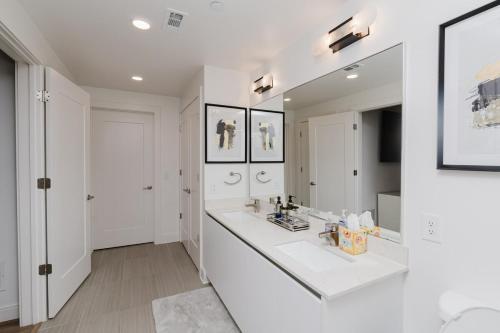 a white bathroom with two sinks and a mirror at Cozy Apartment in Atlanta in Atlanta