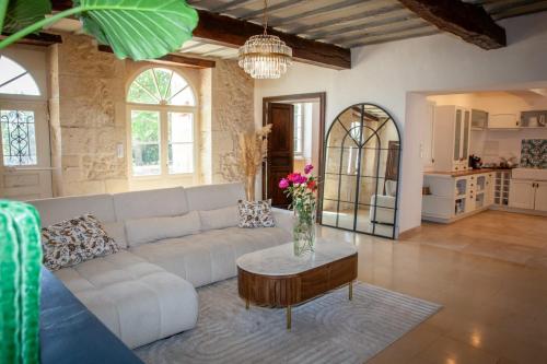 a living room with a white couch and a table at Manoir d Armagnac in Courrensan