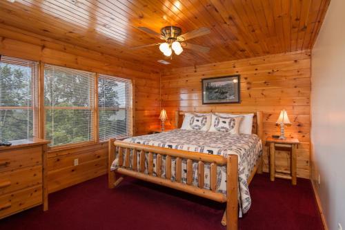 a bedroom with a bed in a log cabin at Moose Lodge by American Patriot Getaways in Walnut Grove