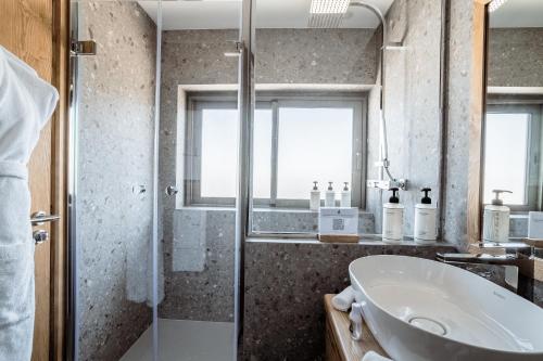 a bathroom with a sink and a shower at Hotel Annapurna in Courchevel