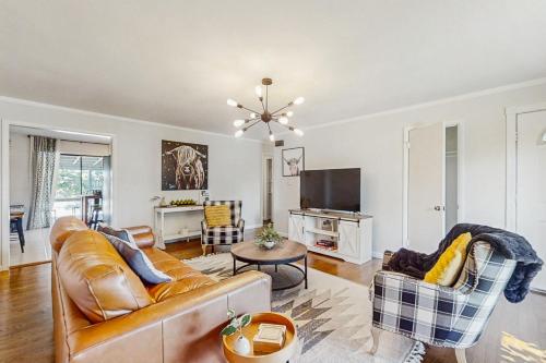 a living room with a couch and a tv at The Torino in Bentonville