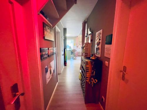 a hallway with a red light in a room at Exklusives Heidehaus in Garlstorf mit Musikzimmer in Garlstorf