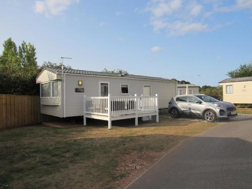 a house with a car parked in front of it at Caravan at Family Park WiFi, Parking in Dawlish Warren