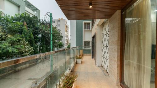 an empty corridor of a building with a balcony at SaffronStays Nivasa Whitefield, Bangalore in Bengaluru