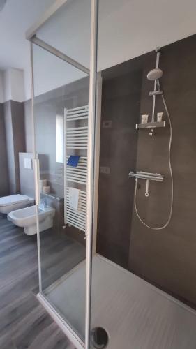a bathroom with a glass shower and a toilet at The View 1 in Teglio