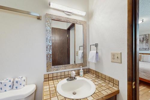 a bathroom with a sink and a mirror and a toilet at East Wenatchee Escape in East Wenatchee