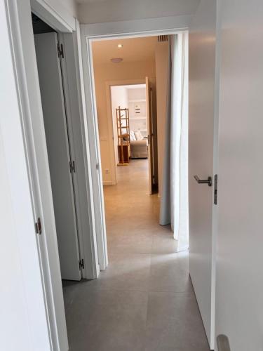 a hallway with white doors and a hallwayngth at Camping Joncar Mar in Roses