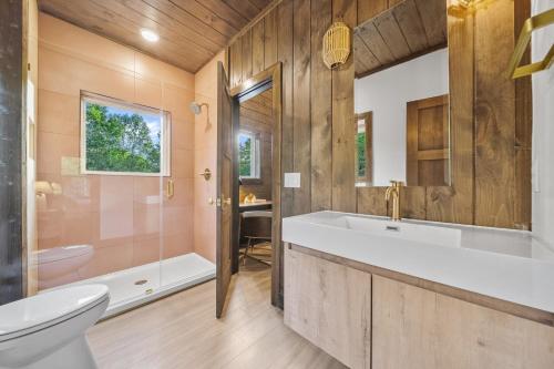 a bathroom with a tub and a toilet and a sink at Stay & Sway Lodge by American Patriot Getaways in Cartertown