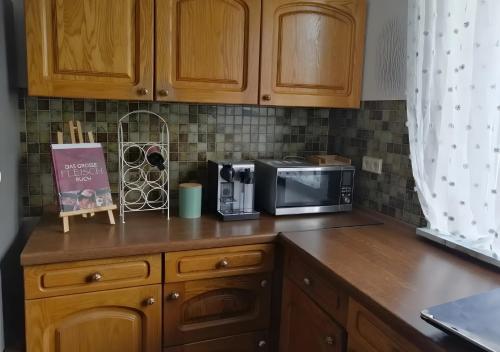 a kitchen with a counter with a microwave and a counter top at Küstenglück in Wilhelmshaven