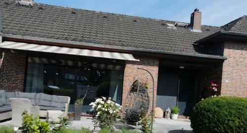 a brick house with a large glass window at Küstenglück in Wilhelmshaven