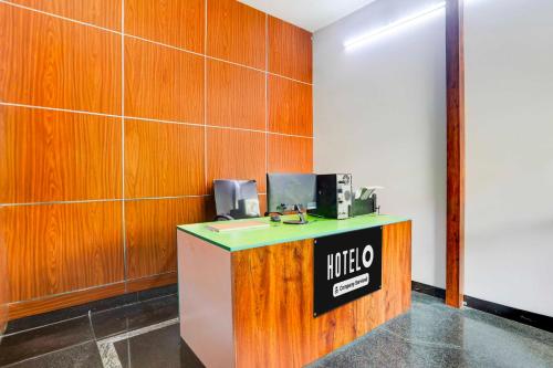 a lobby with a counter with a sign on it at Hotel O Tirupati Railway Junction Y Stay Home Stay in Tirupati