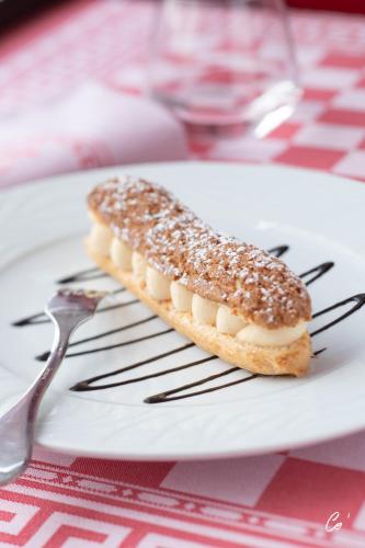 a piece of bread on a plate with a fork at Georges Blanc Parc & Spa in Vonnas