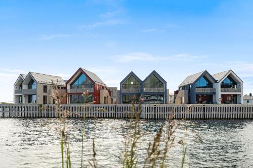 a row of houses on the water at Rorbuleilighet Lysøya 1H in Henningsvær