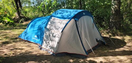 a blue and white tent sitting in the woods at Rent a tent - Namiot w Praekologicznym gospodarstwie in Pozezdrze