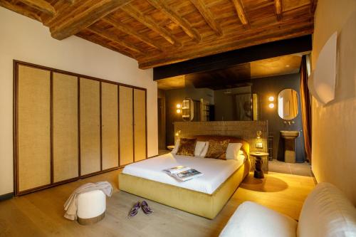 a bedroom with a bed and a couch at Daplace - Palazzo Serpe Suites near Colosseum in Rome