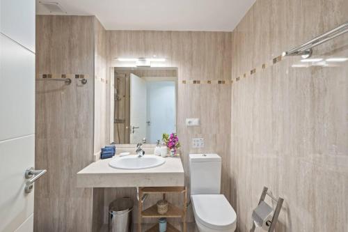 a bathroom with a sink and a toilet and a shower at Casa del Color - Alcaidesa in San Roque