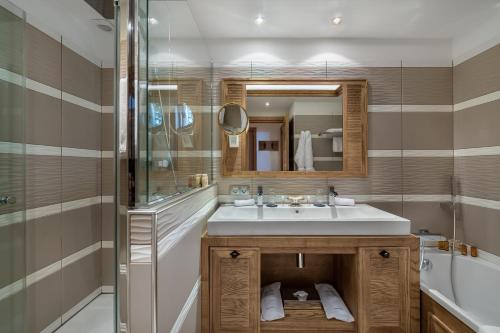 a bathroom with a sink and a shower at Hotel Annapurna in Courchevel