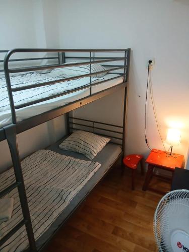 a bedroom with two bunk beds and a table at Smart hostel in Belgrade