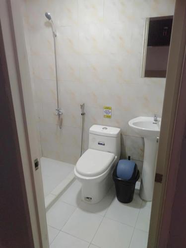 a bathroom with a toilet and a sink at Villa Bella 3 Beach Resort in Buyog
