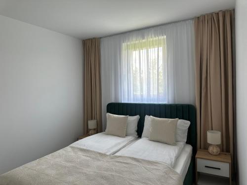 Ένα ή περισσότερα κρεβάτια σε δωμάτιο στο Somogyi Apartman