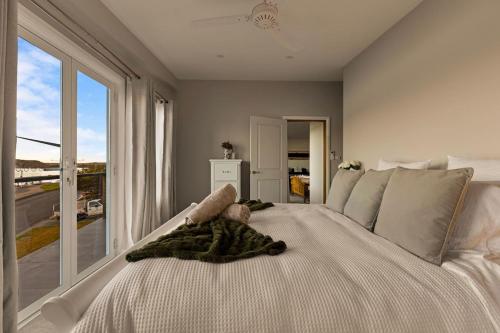 a baby is laying on a bed with a window at Henderson House in Saratoga