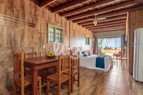 a dining room with a table and a bed at Sea Beach - Loft em Frente ao Mar #1 in Sangão