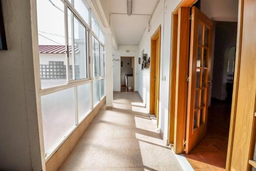an empty hallway with windows in a building at Caparica Beach Stay in Costa da Caparica