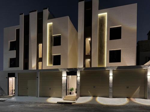 a building with a lot of garage doors in front at Roaa Al-Jamwaut in Al Madinah