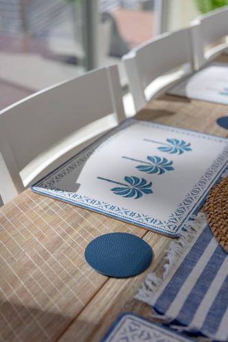 a table with a chair with a napkin on it at New Waterfront Escape with Private Jetty in Woy Woy